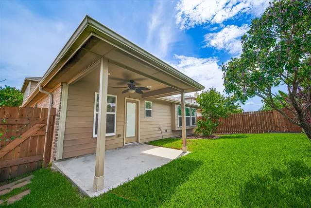 a view of a house with a yard and tree