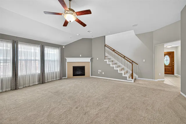 a view of an empty room with a ceiling fan