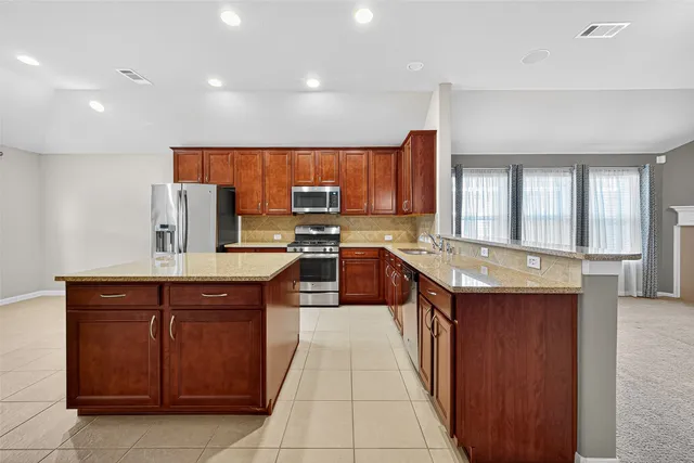 a view of a dining room with furniture and chandelier