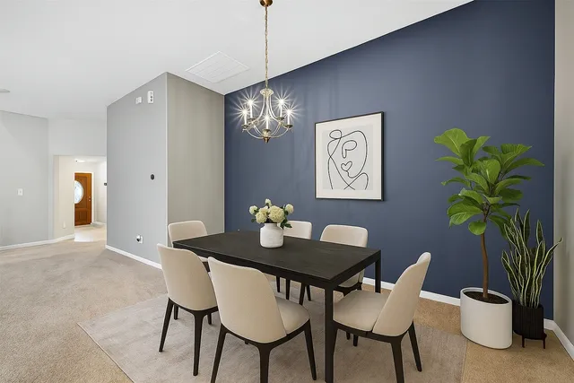 a view of an empty room with a chandelier fan