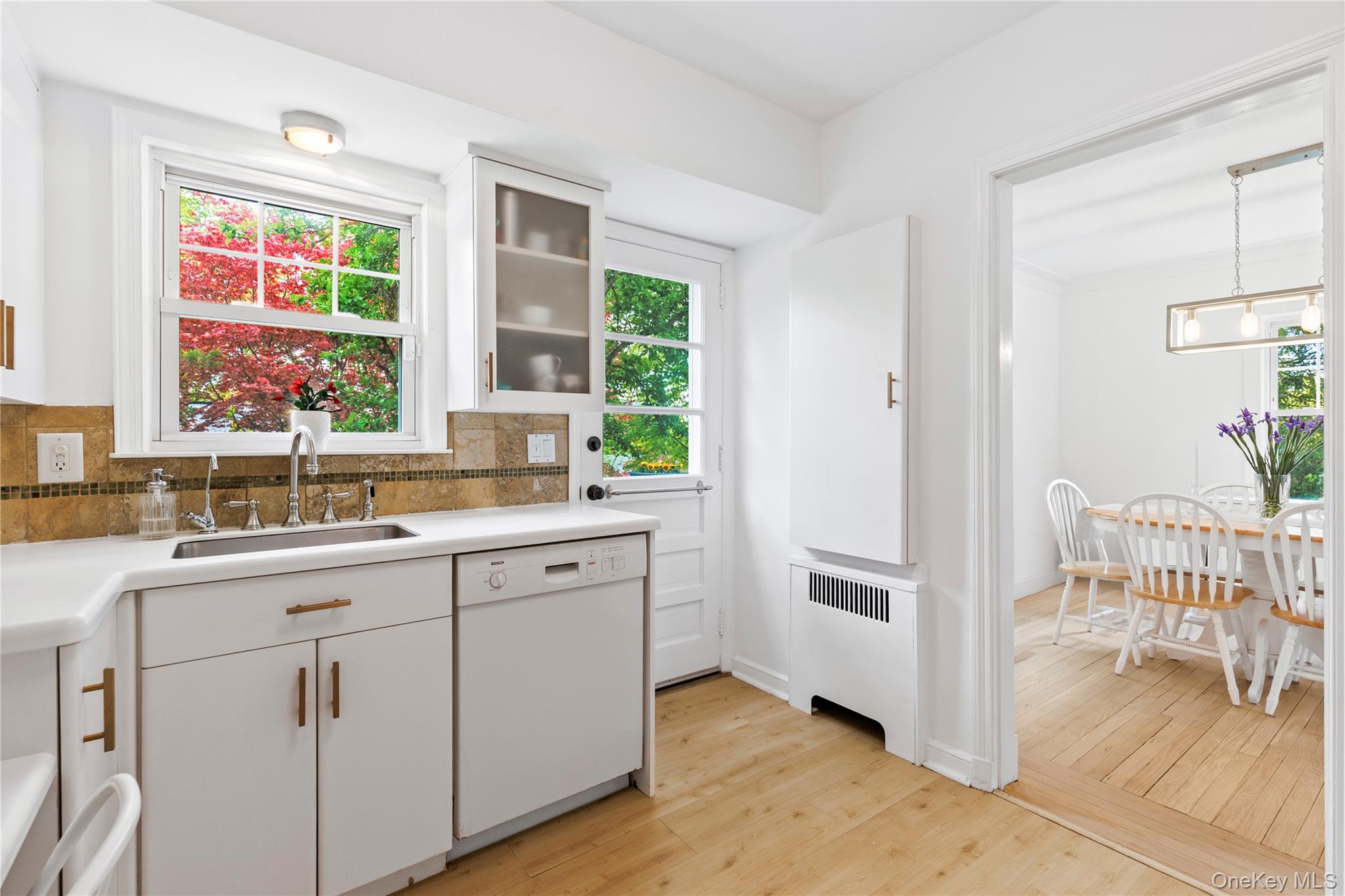 201 Clayton Road Scarsdale, NY 10583 - Photo 12 of 34 Sunny, white updated Kitchen with door out to deck.