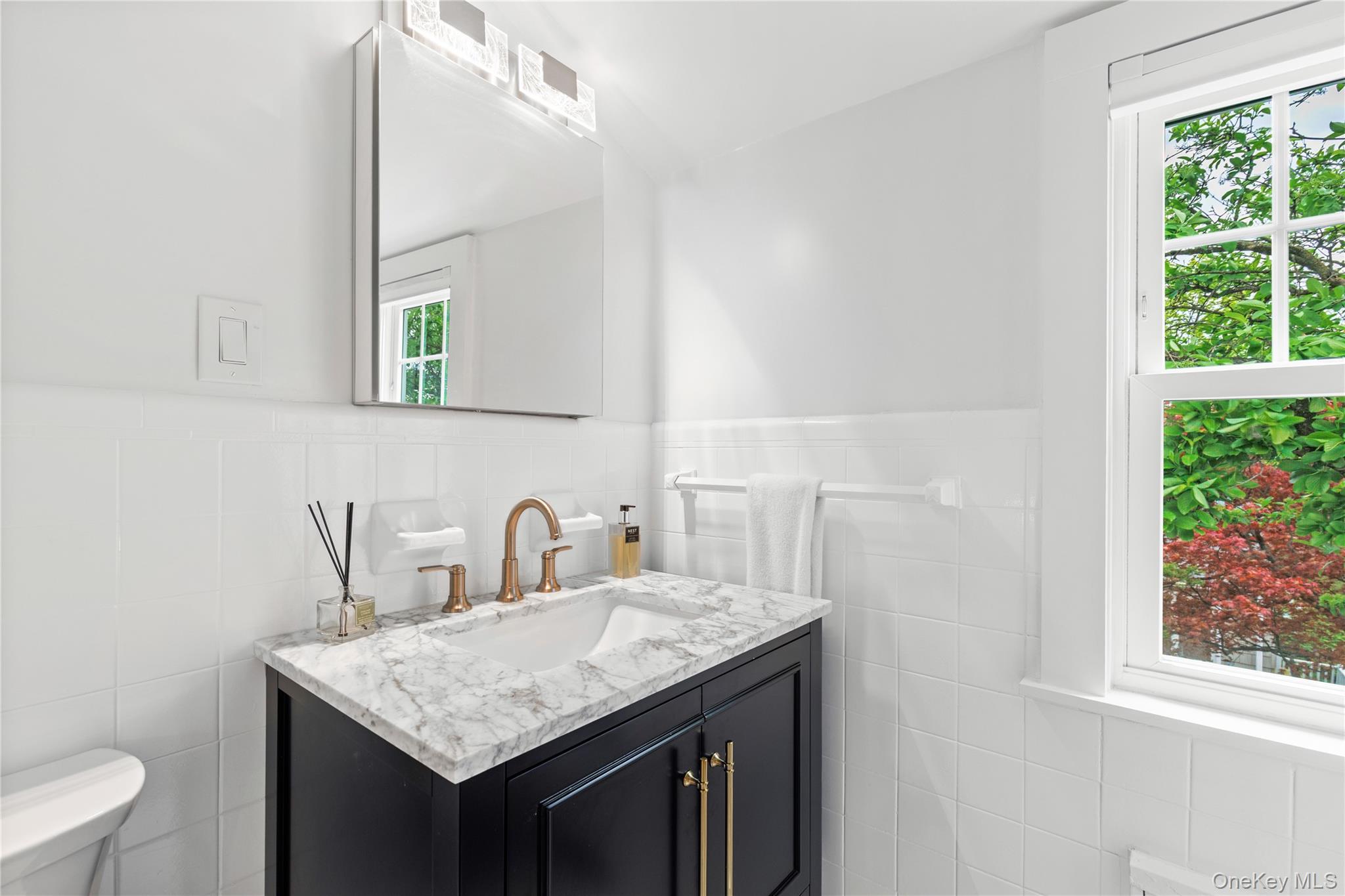 201 Clayton Road Scarsdale, NY 10583 - Photo 22 of 34 Second Floor hall bath is newly tiled with new modern vanity, and a sparkling porcelain tub w/shower.