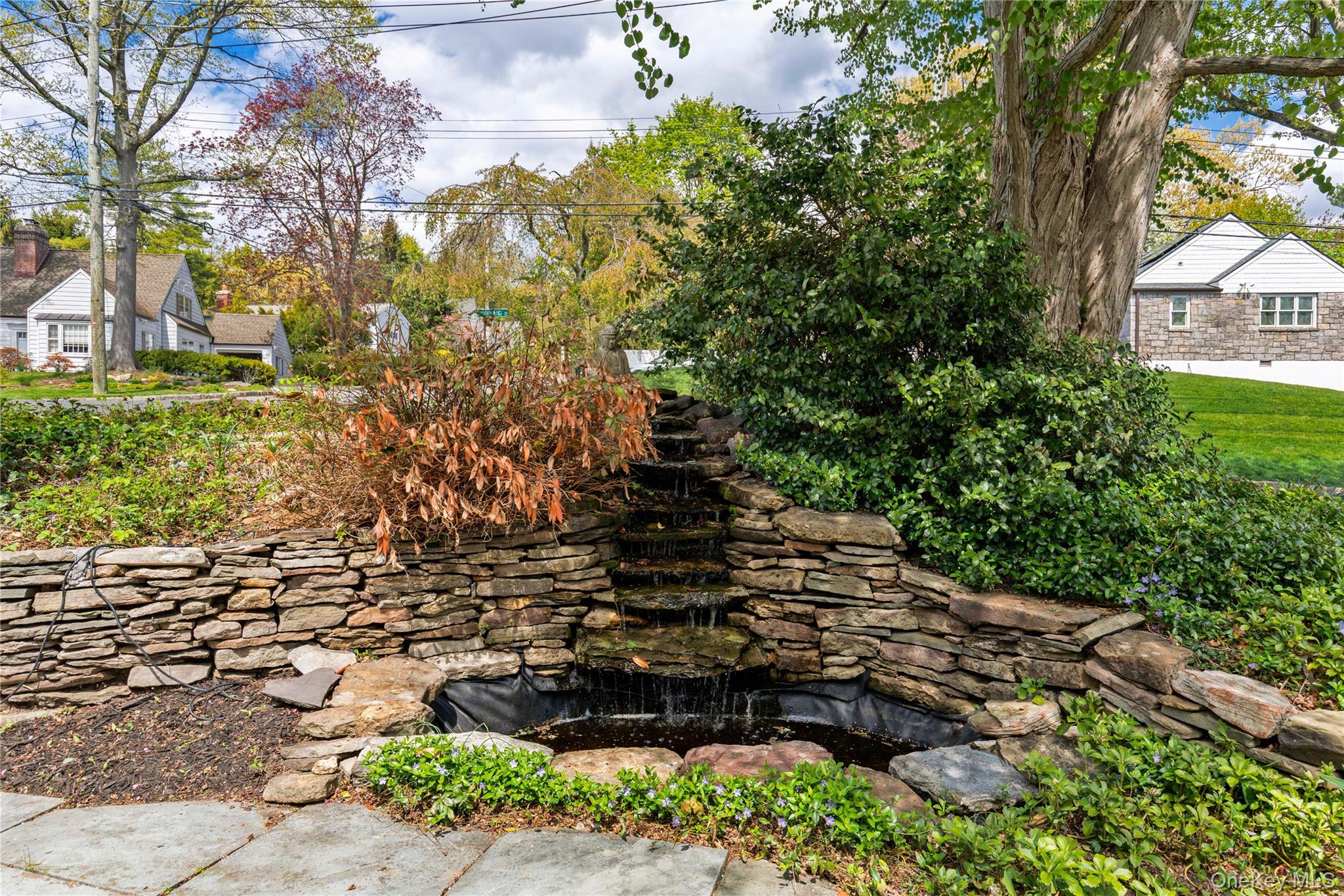 201 Clayton Road Scarsdale, NY 10583 - Photo 29 of 34 Lovely water feature provides a calm, zen-like resting place, surrounded by low stone walls.