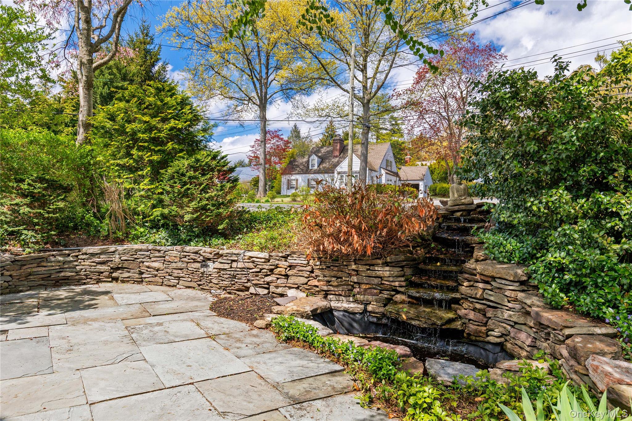 201 Clayton Road Scarsdale, NY 10583 - Photo 30 of 34 Alternate view of the gently cascading fountain, next to a lovely stone patio.