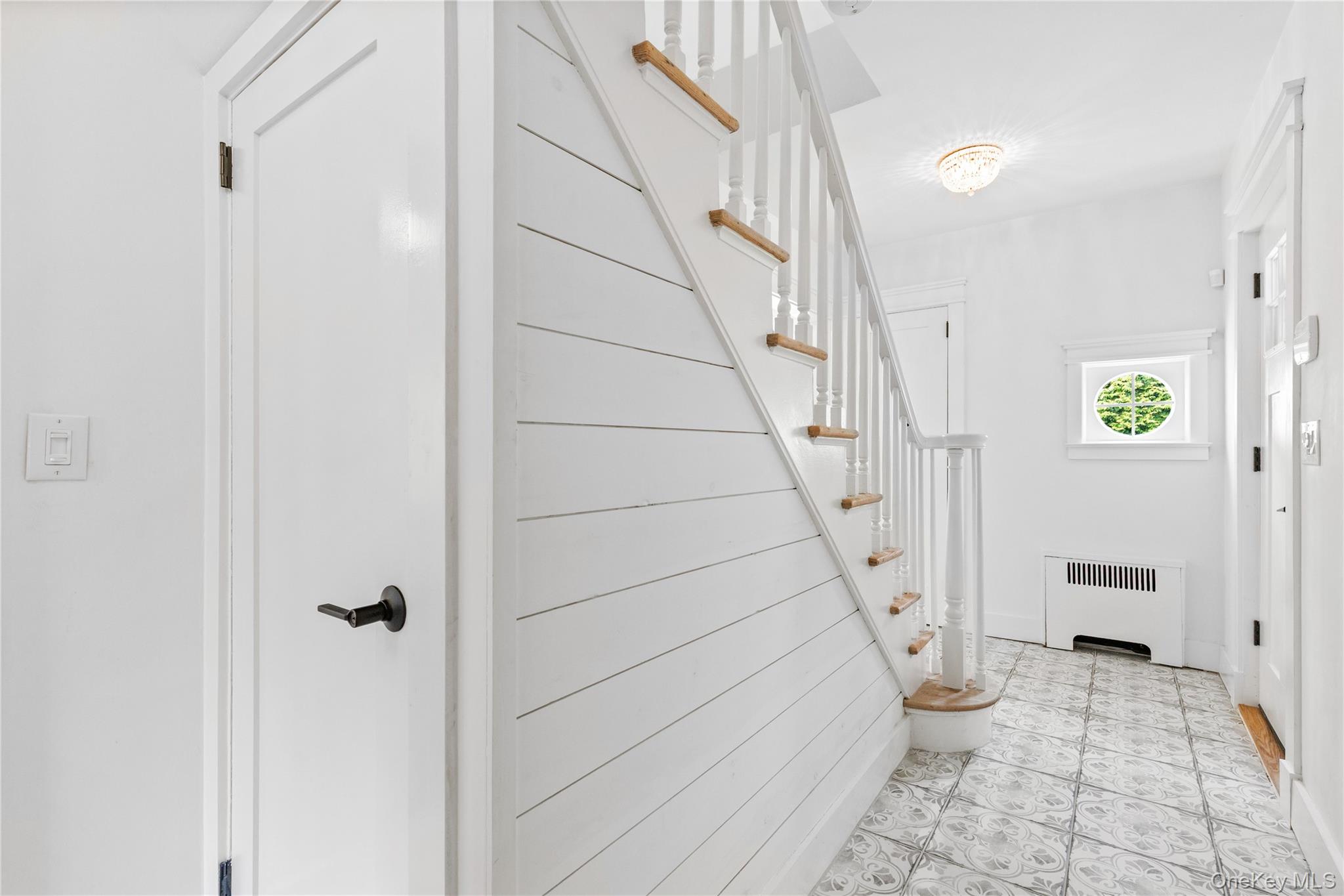201 Clayton Road Scarsdale, NY 10583 - Photo 5 of 34 Alternate view of the Entry Hall, featuring imported Portuguese floor tile and new shiplap wall detailing.