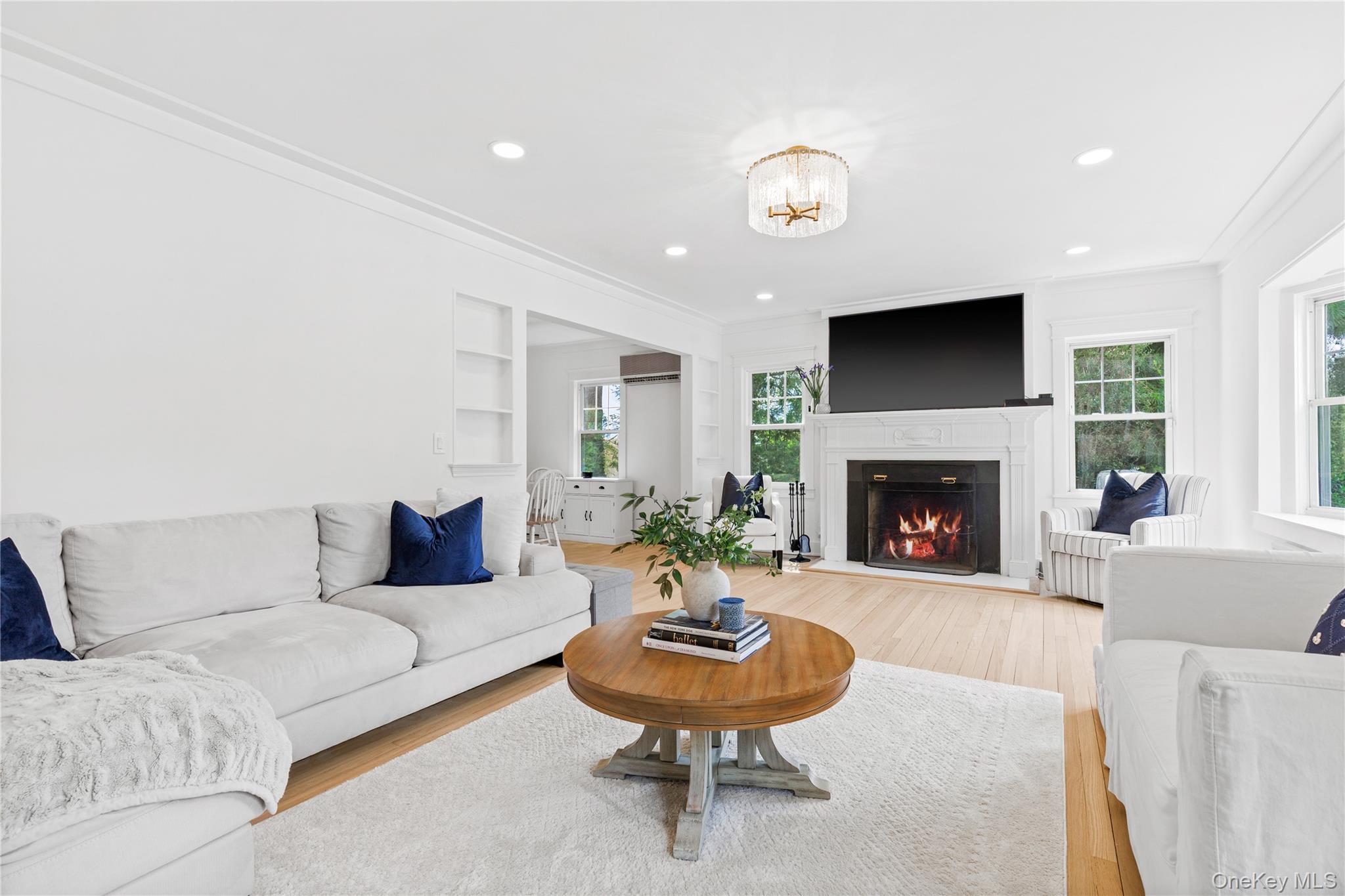201 Clayton Road Scarsdale, NY 10583 - Photo 6 of 34 Stunning Living Room showcases attractive wood-burning fireplace with newly redesigned surround, hearth, and white marble tile.