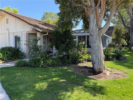 a front view of house with a garden