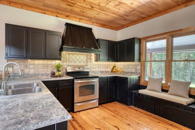 514 Browns Cove Road Blue Ridge, GA 30513 - Photo 15 of 77 a kitchen with granite countertop a stove sink and cabinets