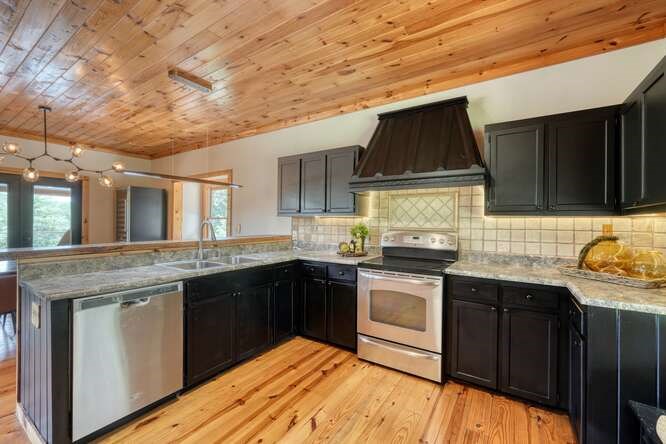 514 Browns Cove Road Blue Ridge, GA 30513 - Photo 17 of 77 a kitchen with stainless steel appliances granite countertop a stove a sink and a microwave
