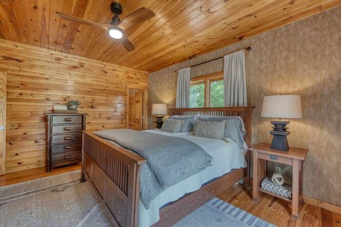 514 Browns Cove Road Blue Ridge, GA 30513 - Photo 23 of 77 a bedroom with a bed and a table