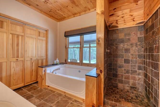 514 Browns Cove Road Blue Ridge, GA 30513 - Photo 25 of 77 a bathroom with a bathtub and next to a window