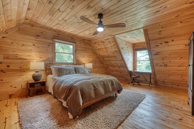 514 Browns Cove Road Blue Ridge, GA 30513 - Photo 29 of 77 a spacious bedroom with a bed and wooden floor