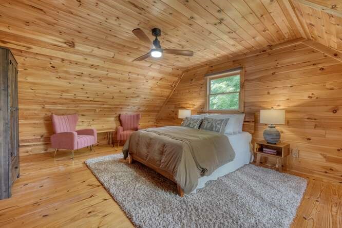 514 Browns Cove Road Blue Ridge, GA 30513 - Photo 30 of 77 a bedroom with a bed and wooden floor