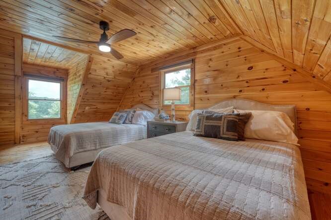 514 Browns Cove Road Blue Ridge, GA 30513 - Photo 33 of 77 a spacious bedroom with two beds and a chandelier