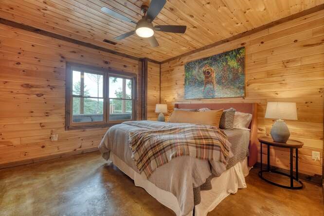 514 Browns Cove Road Blue Ridge, GA 30513 - Photo 42 of 77 a bedroom with a bed and wooden floor