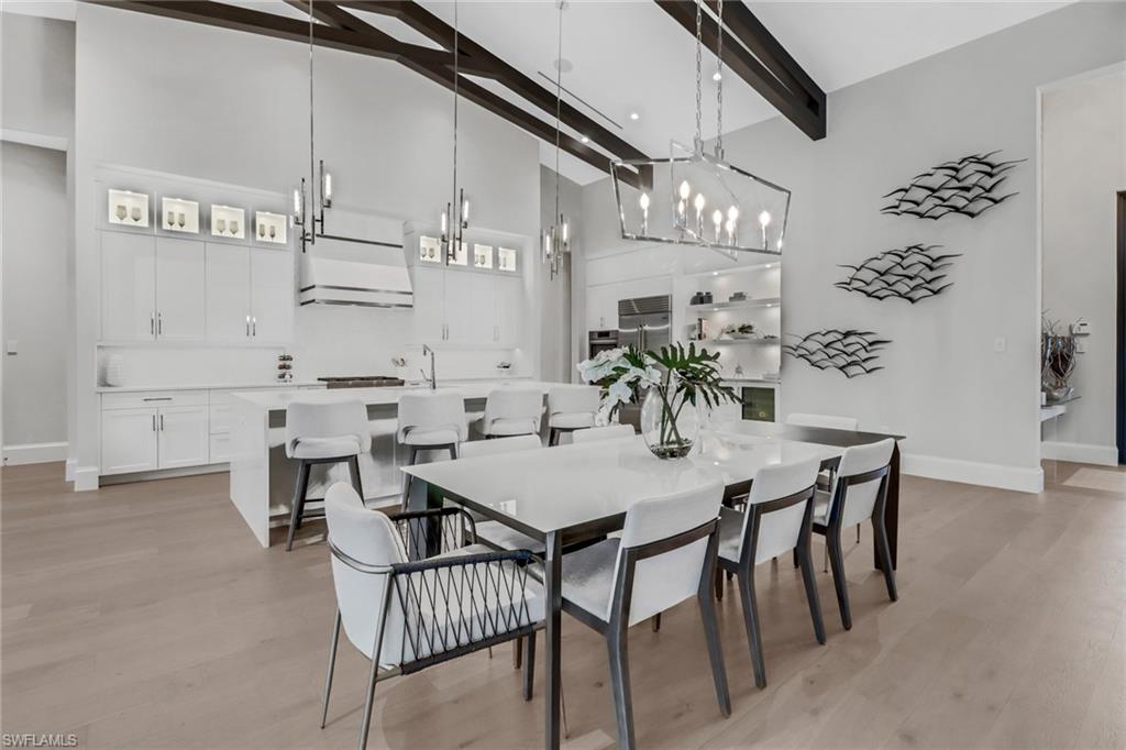 12 Banyan Road Naples, FL 34108 - Photo 12 of 50 a view of a dining room with furniture and wooden floor
