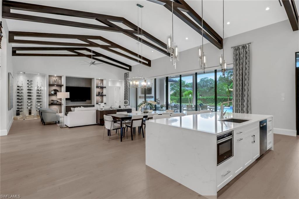 12 Banyan Road Naples, FL 34108 - Photo 15 of 50 a living room with furniture and a flat screen tv