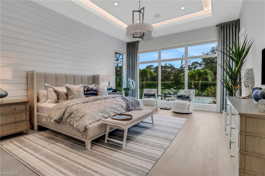 12 Banyan Road Naples, FL 34108 - Photo 18 of 50 a bedroom with a bed and a couch