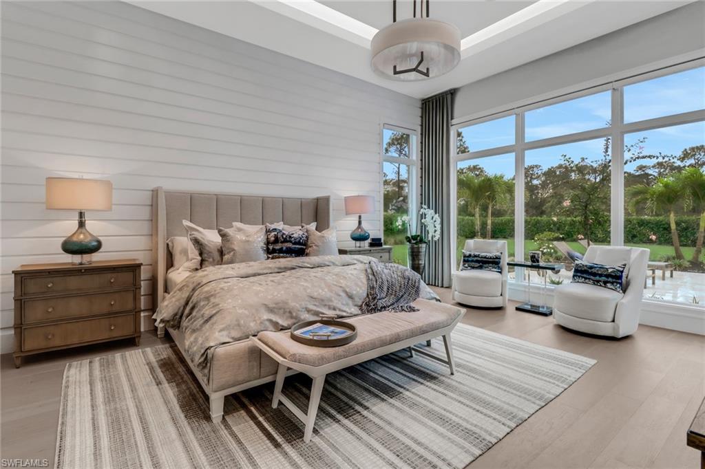 12 Banyan Road Naples, FL 34108 - Photo 19 of 50 a spacious bedroom with a bed and a large window