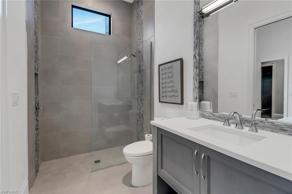 12 Banyan Road Naples, FL 34108 - Photo 28 of 50 a bathroom with a sink a toilet and shower