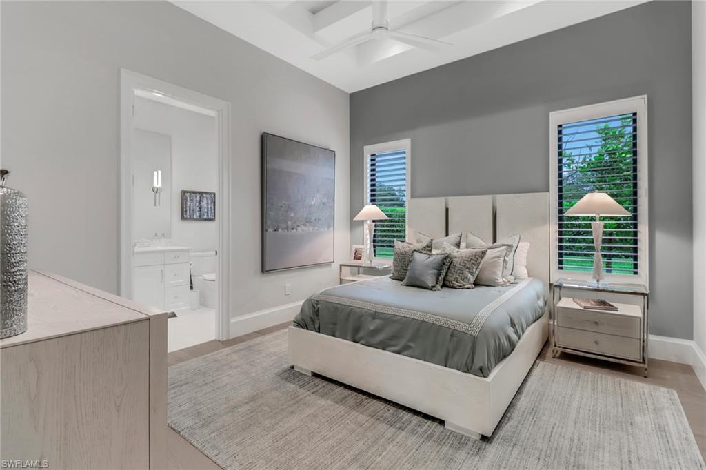 12 Banyan Road Naples, FL 34108 - Photo 29 of 50 a bedroom with a bed and a large window