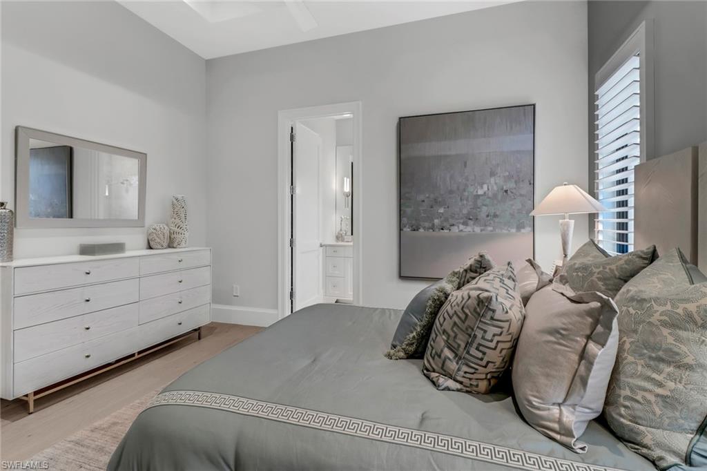 12 Banyan Road Naples, FL 34108 - Photo 30 of 50 a bedroom with a bed and a dresser