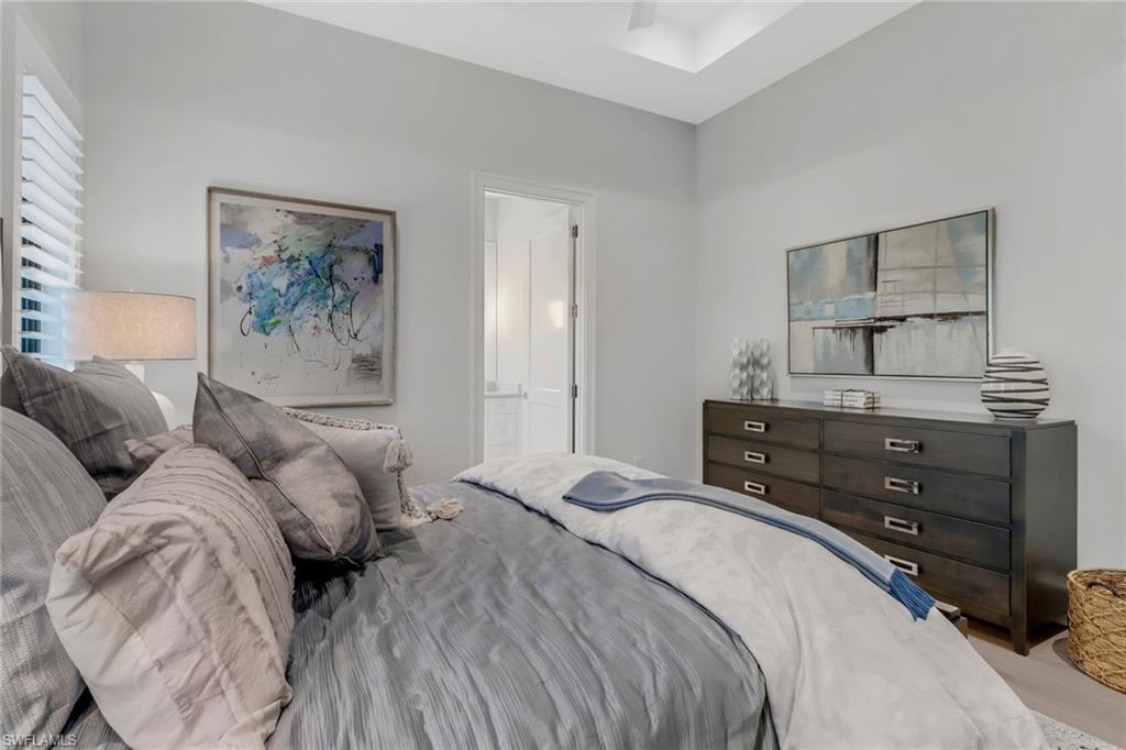 12 Banyan Road Naples, FL 34108 - Photo 33 of 50 a bedroom with a bed and a dresser