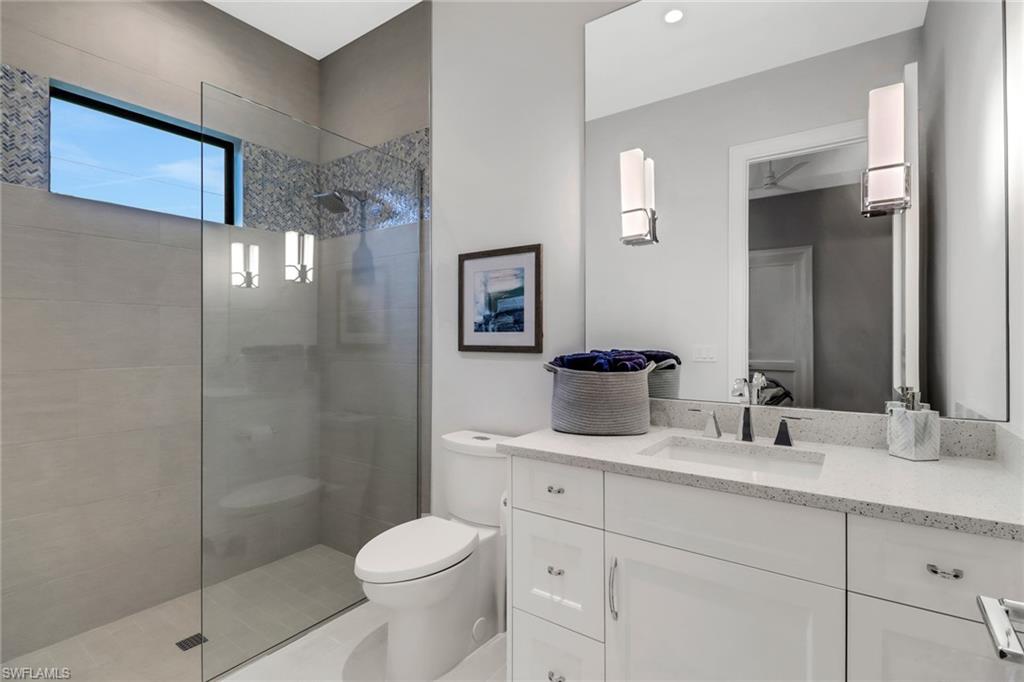 12 Banyan Road Naples, FL 34108 - Photo 34 of 50 a bathroom with a toilet sink and shower