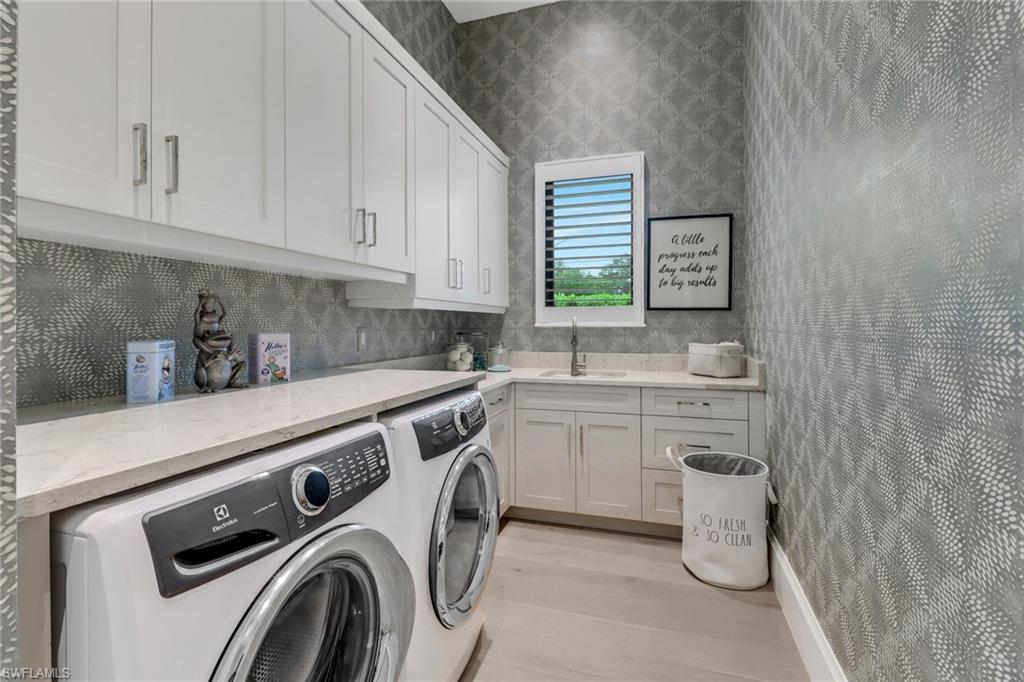 12 Banyan Road Naples, FL 34108 - Photo 35 of 50 a kitchen with a sink a stove and cabinets