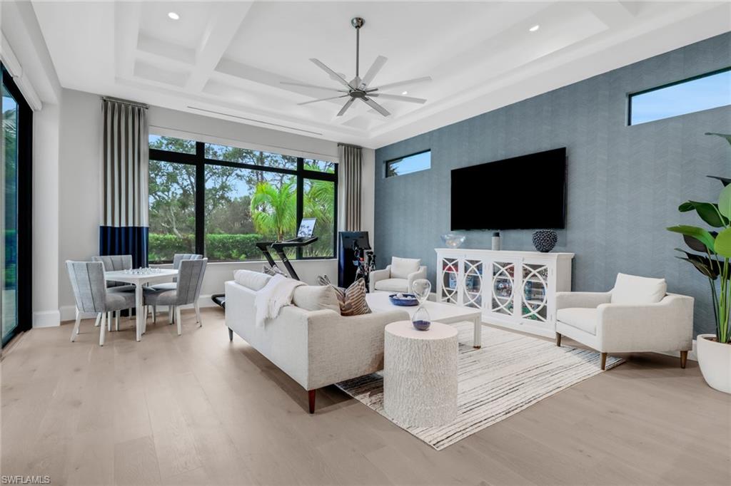 12 Banyan Road Naples, FL 34108 - Photo 37 of 50 a living room with furniture and a flat screen tv