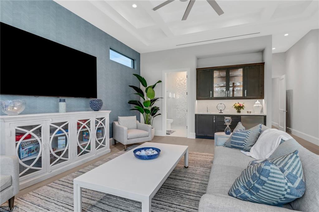 12 Banyan Road Naples, FL 34108 - Photo 38 of 50 a living room with furniture and a flat screen tv