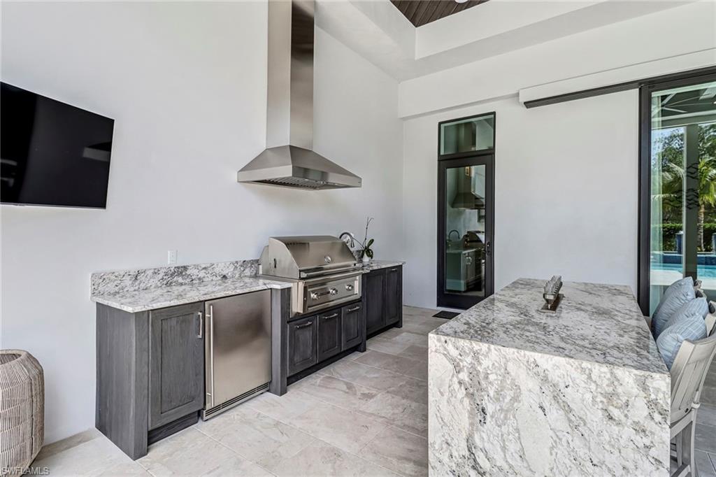 12 Banyan Road Naples, FL 34108 - Photo 40 of 50 a kitchen with stainless steel appliances granite countertop a stove and a sink