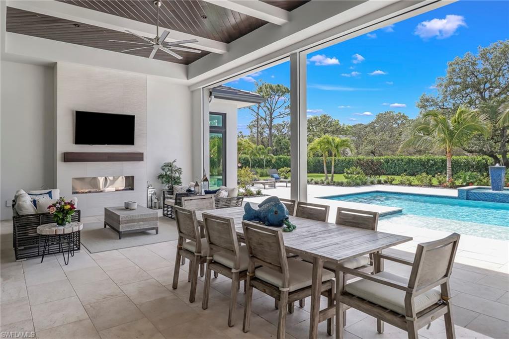 12 Banyan Road Naples, FL 34108 - Photo 42 of 50 a dining room with furniture and a floor to ceiling window