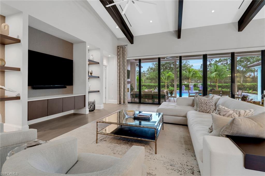 12 Banyan Road Naples, FL 34108 - Photo 6 of 50 a living room with furniture and a flat screen tv