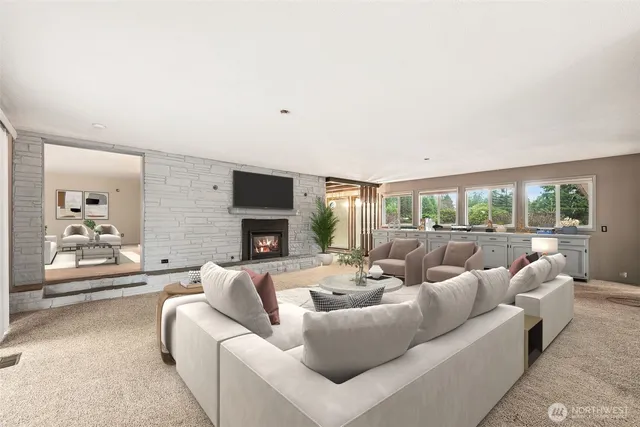 a living room with fireplace furniture and a large window