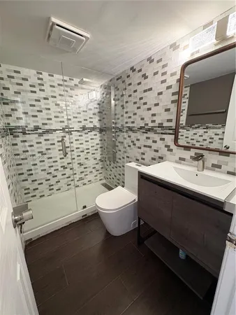 a bathroom with a sink toilet and shower