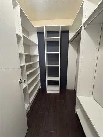 a view of walk in closet with empty racks