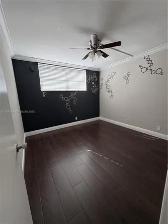 a view of a livingroom with a ceiling fan and window