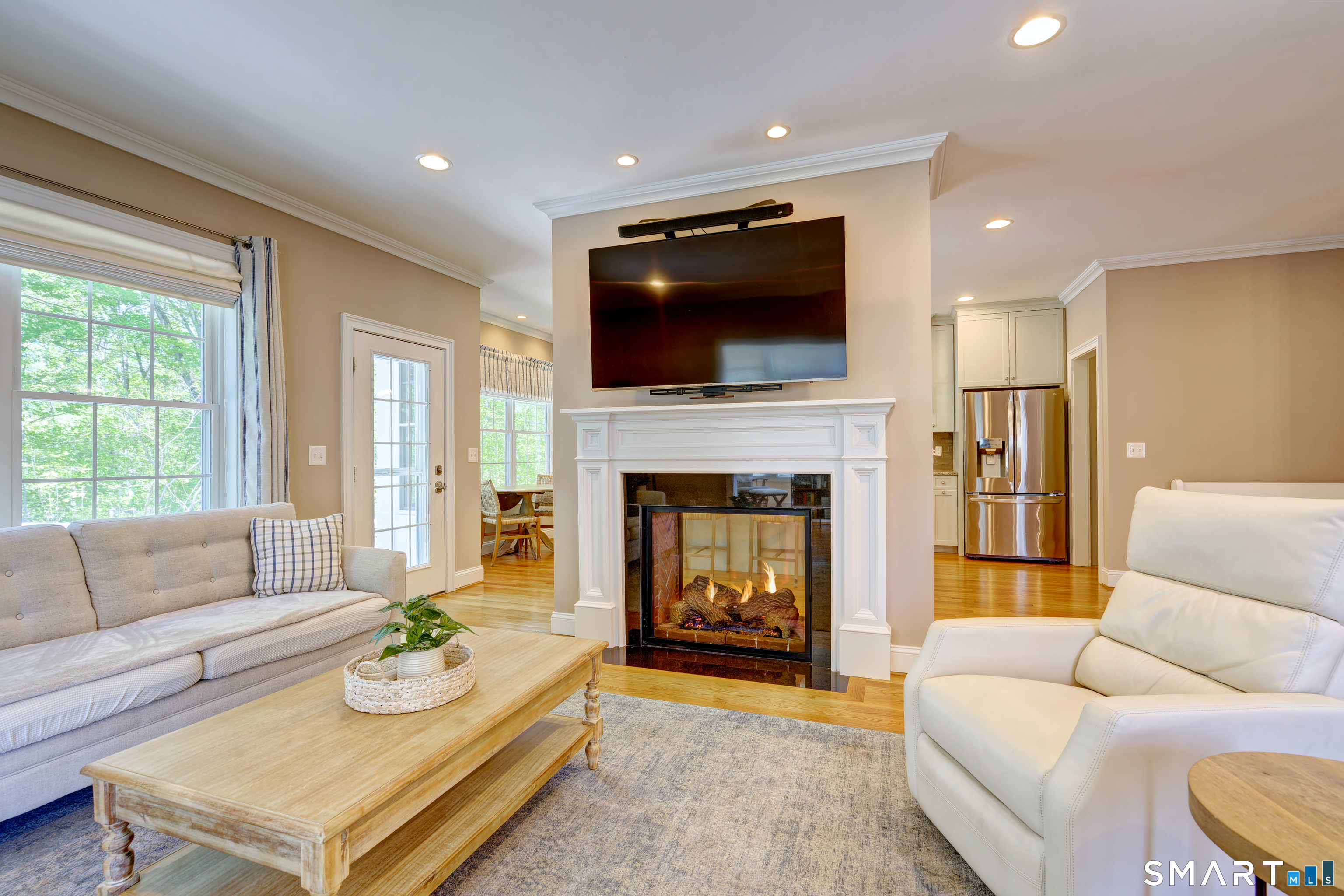 15 Tryon Farm Road Glastonbury, CT 06073 - Photo 12 of 40 Warm and Welcoming Living Room Featuring a Double-Sided Gas Fireplace