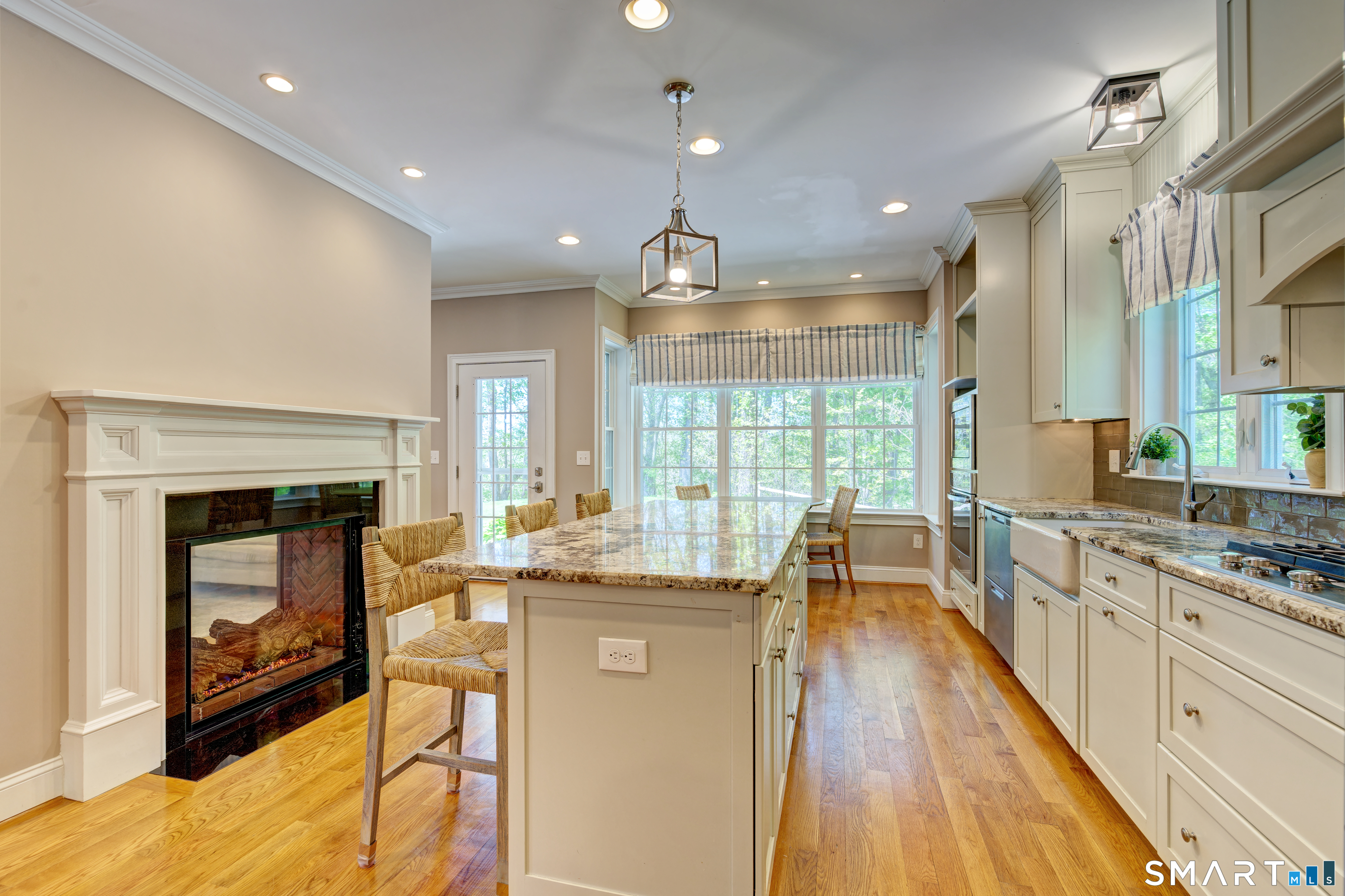 15 Tryon Farm Road Glastonbury, CT 06073 - Photo 15 of 40 Enjoy the Warmth of a Double-Sided Gas Fireplace in the Kitchen