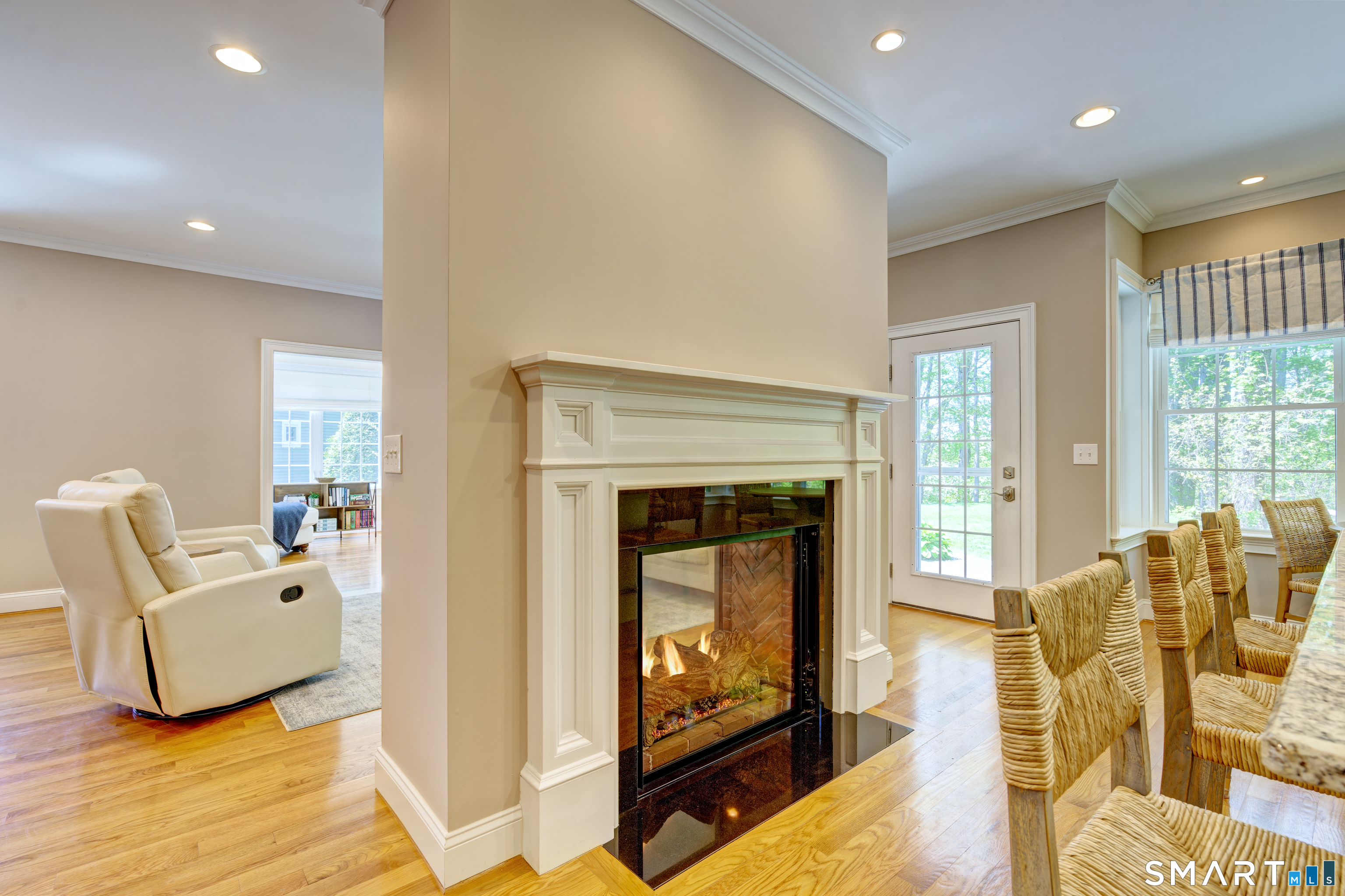 15 Tryon Farm Road Glastonbury, CT 06073 - Photo 16 of 40 Enjoy the Warmth of a Double-Sided Gas Fireplace Shared Between the Living Room and Kitchen