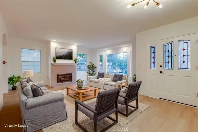 a view of an empty room with a window and fireplace