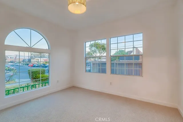 an empty room with windows and closet
