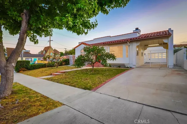 a view of a dining room with furniture and a potted plant