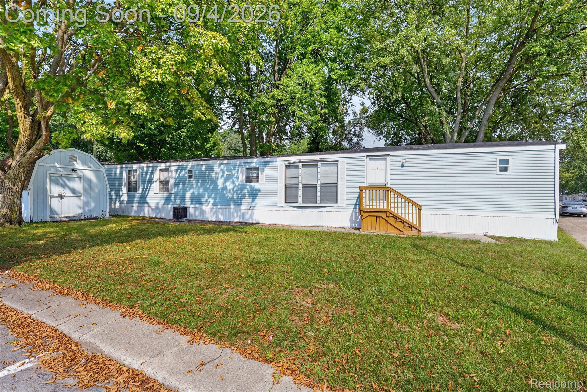 51074 Mott Road, Unit 200 Canton, MI 48188 - Photo 22 of 24 Light blue vinyl siding exterior with white trim
