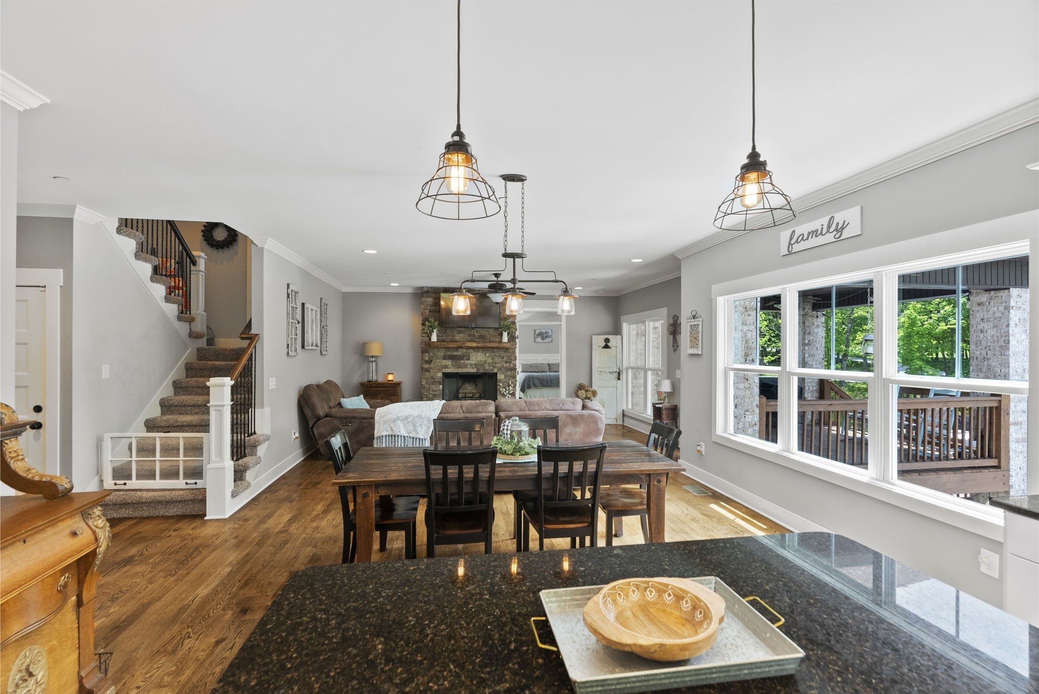2764 New Hall Road Greenbrier, TN 37073 - Photo 15 of 44 a view of a dining room and livingroom with furniture wooden floor a chandelier