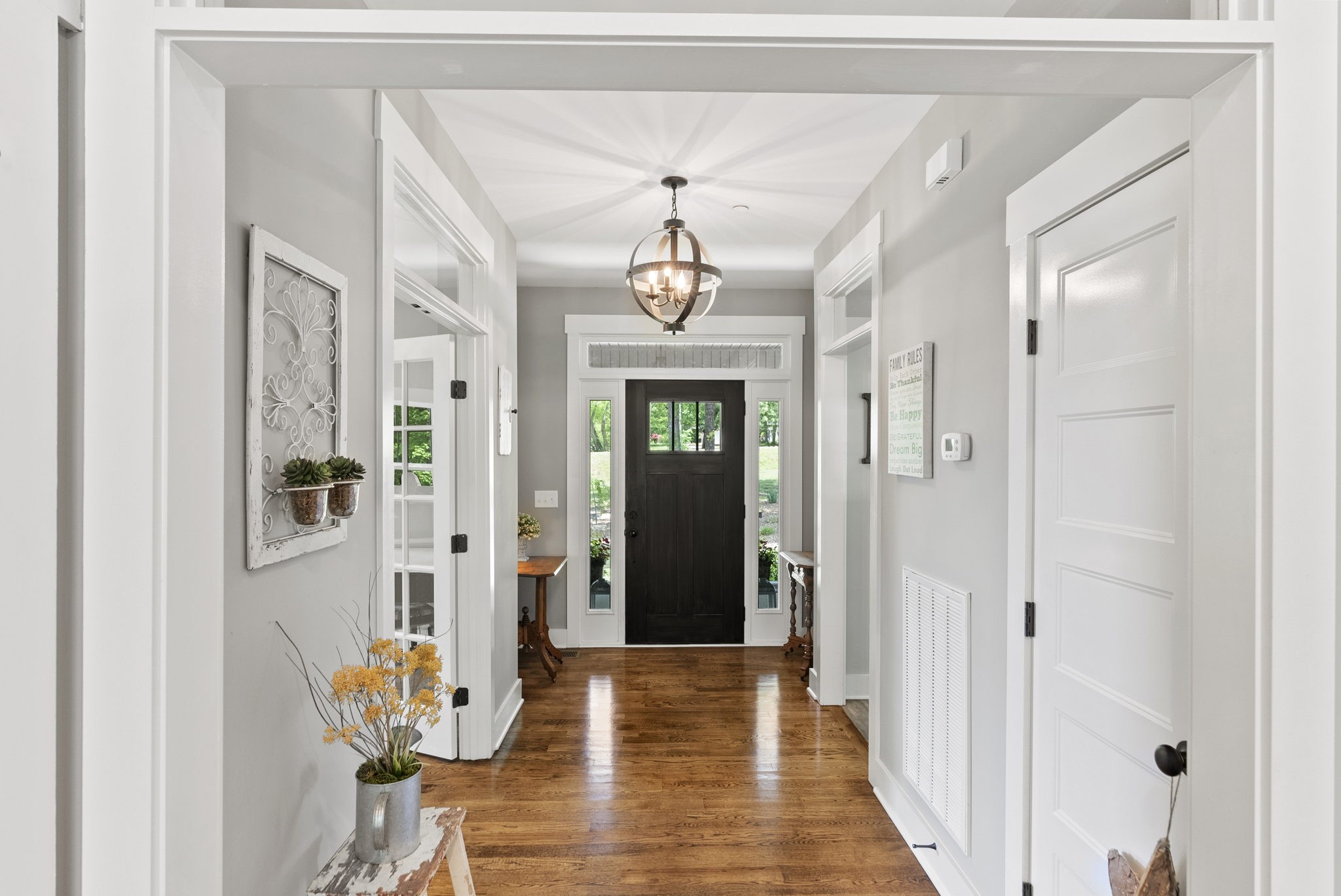 2764 New Hall Road Greenbrier, TN 37073 - Photo 7 of 44 a view of a hallway with wooden floor and a chandelier