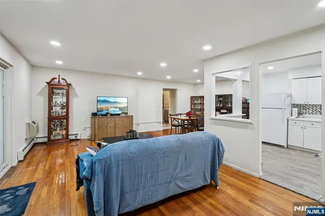 a living room with furniture and kitchen view
