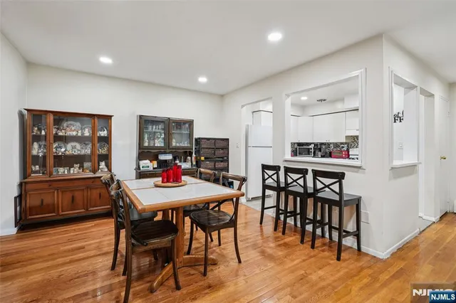 a view of a dining room with furniture and wooden floor
