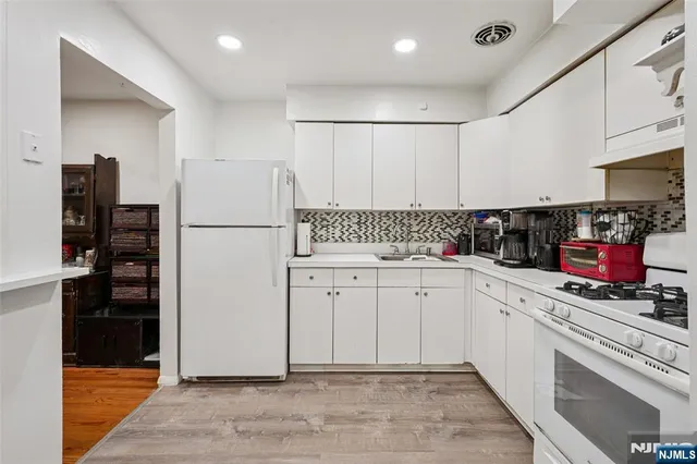 a kitchen with refrigerator and cabinets